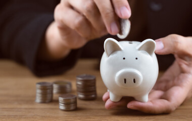 Money coin stack and piggy bank for saving money, wealth and financial concept. Crop close up photo. Investment for rich, retirement. Financial management for future or deposit money for family.