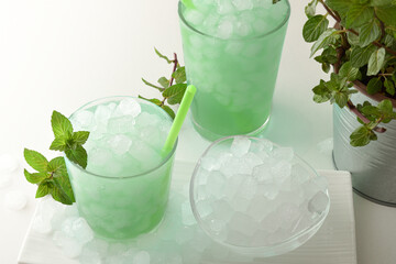 Wall Mural - Two glasses of refreshing mint drink and bowl with ice