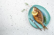 grilled fish dorado on a light background. banner, menu, recipe place for text, top view