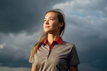 Poster - Medium shot portrait photography of a joyful girl in her 30s wearing a sporty polo shirt against a dramatic thunderstorm background. With generative AI technology