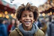 © Markus Schröder - Conceptual portrait photography of a grinning kid male wearing a cozy sweater against a crowded amusement park background. With generative AI technology