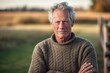 © Markus Schröder - Close-up portrait photography of a glad mature man wearing a cozy sweater against a sprawling ranch background. With generative AI technology