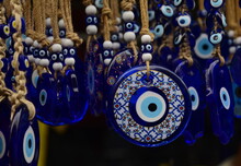 Nazar In Market. Blue And Red Fatima Eye Close-up Protective Amulet Against Evil Eye. Israeli And Turkish Souvenir. 