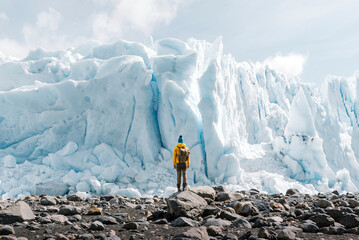 A man posing on the ice formation of the Perito Moreno glacier, Argentina