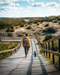 Traveler man in yellow jacket walks next to a penguin in Argentine Patagonia