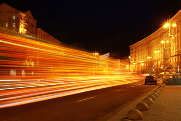 Wall Mural - Road traffic, motion blur effect. View of night cityscape with car light trails