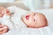 Laugh, portrait and a baby on the bed with mother for play, bonding and wake up in the morning. Smile, house and a little newborn child in the bedroom for happiness, care and together with mom