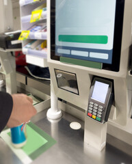 Customer pays his purchase at the supermarket,self checkout systems in  retail stores,Barcode scanner,Self checkout machine