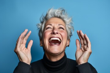 Poster - Headshot portrait photography of a joyful mature woman putting hands on the face in a gesture of terror against a sky-blue background. With generative AI technology