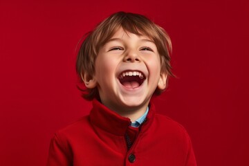 Poster - Medium shot portrait photography of a happy kid male placing the hand over the mouth in a laughter gesture against a ruby red background. With generative AI technology