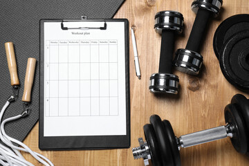 clipboard with workout plan and sports equipment on wooden table, flat lay. personal training