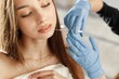 © prostooleh - Young caucasian woman having lip injection at beauty center