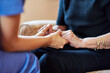 © Cecilie Arcurs/peopleimages.com - Nurse, senior people and holding hands for support, healthcare service and medical, advice and empathy. Professional doctor, helping and retirement nursing for elderly person in together sign closeup