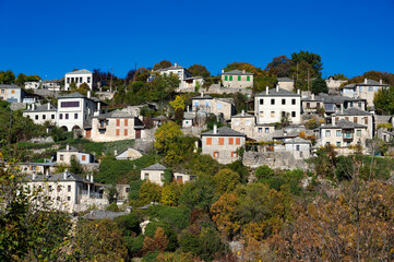 Wall Mural - Autumnal landscape showing the stone houses of traditional architecture in the village of Vitsa in Zagori of Epirus, Greece