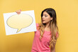 © luismolinero - Young Russian girl isolated on yellow background holding a placard with speech bubble icon