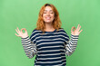 Young caucasian woman isolated on green screen chroma key background in zen pose