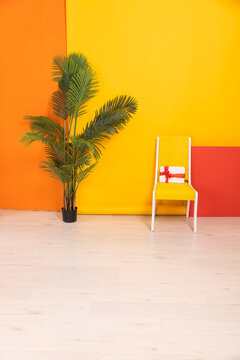 yellow chair with gift decorative flower on yellow orange background in room interior furniture