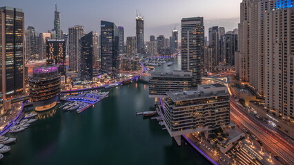 Wall Mural - Aerial view to Dubai marina skyscrapers around canal with floating boats day to night timelapse