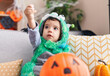 © Krakenimages.com - Adorable hispanic boy having halloween party holding sweets at home