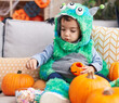 © Krakenimages.com - Adorable hispanic boy having halloween party holding sweets at home