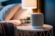 A smart home smart speaker sits on a table next to a lamp. Generative AI