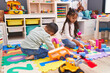 © Krakenimages.com - Adorable boy and girl playing with construction blocks at kindergarten