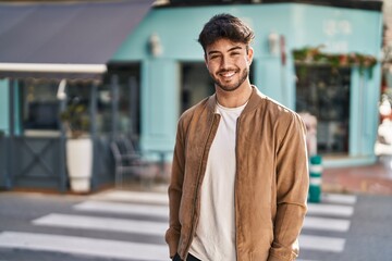 Canvas Print - Young hispanic man smiling confident standing at street