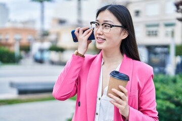 Sticker - Chinese woman business worker listening voice message by smartphone drinking coffee at park