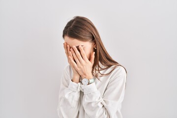 Poster - Young caucasian woman standing over isolated background with sad expression covering face with hands while crying. depression concept.