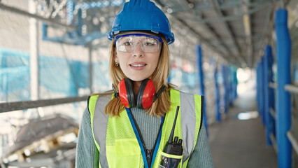 Poster - Young blonde woman builder smiling confident standing at street