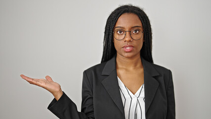 Sticker - African american woman business worker standing with serious expression presenting over isolated white background