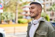 © Krakenimages.com - Young hispanic man smiling confident wearing headphones at park