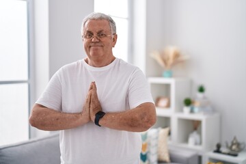 Canvas Print - Middle age grey-haired man smiling confident training yoga at home