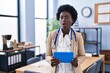 © Krakenimages.com - African young woman wearing doctor stethoscope afraid and shocked with surprise and amazed expression, fear and excited face.