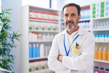 Poster - Middle age man pharmacist standing with arms crossed gesture at pharmacy