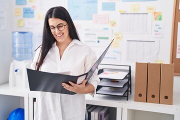 Sticker - Young beautiful hispanic woman business worker reading document at office