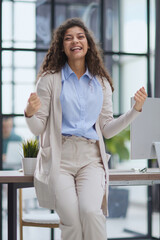 Happy woman screams make a winner gesture with clenched fists