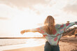 © Daniel - One happy beautiful woman walking on the sand of the beach enjoying and having fun at the sunset of the day. Leisure time on vacations, freedom concept.