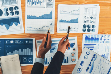Poster - Top view analyst team discussing financial data on digital dashboard, analyzing chart and graph papers by data science software on wooden table background. Business intelligence and Fintech. Fervent