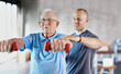 © Y.A./peopleimages.com - Physiotherapist, senior man and rehabilitation with dumbbells, fitness and exercise for recovery, help and training. Mature male person, client or employee with equipment, physical therapy and health