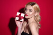 © Volodymyr - Young woman hold gift, isolated on studio background. Holidays celebration concept. Celebrating birthday, receive gift present. Surprised woman with gift. Portrait of attractive woman with gift.
