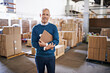 © Y.A./peopleimages.com - Checklist, smile and portrait of man in warehouse for cargo, storage and shipping. Distribution, ecommerce and logistics with employee in factory plant for supply chain, package or wholesale supplier