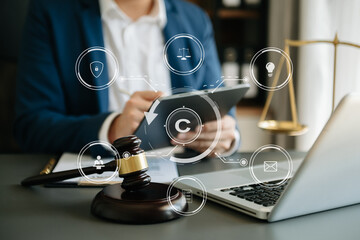 Wall Mural - Copyright or patent concept, Person hand using laptop computer, tablet and smartphone with virtual screen copyright icon trademark, Creation ownership against piracy. at office.