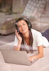 Canvas Print - Laptop, headphones and a woman listening to music on a home sofa with internet for streaming online. Happy female person relax on couch with tech to listen to audio, radio or podcast for peace