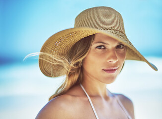 Wall Mural - Travel, vacation and portrait of woman at beach for summer, tropical and relax mockup. Wellness, nature and holiday with face of female tourist and hat at seaside for sunbathing and paradise