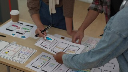 Close up ux developer and ui designer brainstorming interface wireframe design.Creative digital development agency
