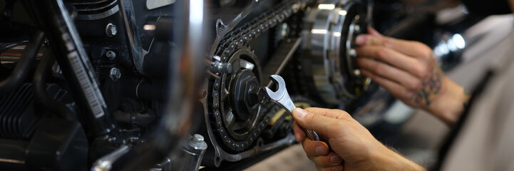 Wall Mural - Maintenance of motorcycle engine clutch system by technicians. Repair and diagnostics of motorcycle engine breakdown concept