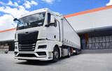 white truck in front of the warehouse, a loading truck