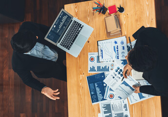 Poster - Top view analyst team discussing financial data on digital dashboard, analyzing chart and graph papers by data science software on wooden table background. Business intelligence and Fintech. Fervent