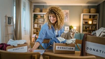 Wall Mural - One young adult woman prepare wardrobe clothes for charity donation